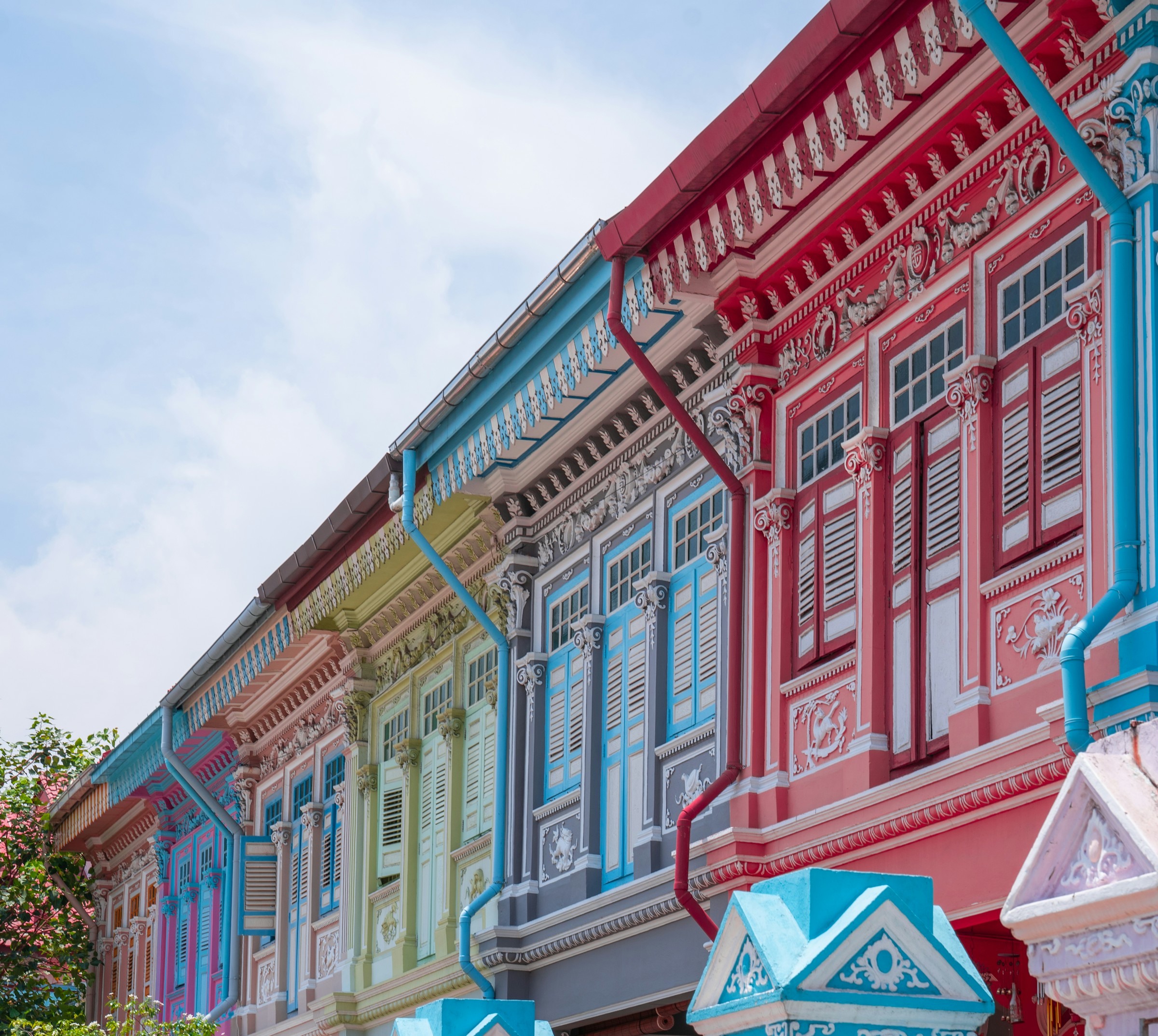Candy-coloured Peranakan heritage shophouses in Joo Chiat / Katong, Singapore — bright daylight